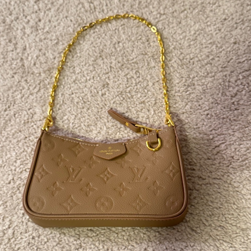 Tan monogram purse with gold accents